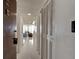 Hallway with neutral walls and doors leading to living area with natural light, creating an inviting space at 925 N Halifax Ave # 910, Daytona Beach, FL 32118