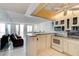 Bright kitchen featuring modern appliances and a breakfast bar overlooking the living area at 925 N Halifax Ave # 910, Daytona Beach, FL 32118