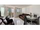 Open-concept living room with balcony access and city views, next to the dining area at 925 N Halifax Ave # 910, Daytona Beach, FL 32118
