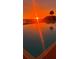 Sunrise view of community pool with palm tree, creating a serene and inviting atmosphere at 925 N Halifax Ave # 910, Daytona Beach, FL 32118