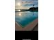 Sunrise view of community pool with calming waters with a view of the morning skies at 925 N Halifax Ave # 910, Daytona Beach, FL 32118