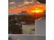 Beautiful sunrise view overlooking neighborhood architecture and lush landscaping with ocean in background at 925 N Halifax Ave # 910, Daytona Beach, FL 32118