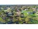 Aerial view of homes near a lake and lush green trees at 951 Lovington Dr, Deltona, FL 32738