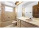 Functional bathroom with a tub, vanity with storage, and neutral tiling at 951 Lovington Dr, Deltona, FL 32738