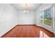 Elegant dining room featuring tile floors, a chandelier, and a bay window with natural light at 951 Lovington Dr, Deltona, FL 32738