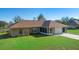 Exterior of a charming brick home with a well-manicured lawn and attached garage at 951 Lovington Dr, Deltona, FL 32738
