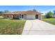 Charming single-story brick home with a well-manicured lawn and a spacious two-car garage at 951 Lovington Dr, Deltona, FL 32738