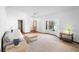 Bright living room featuring neutral carpet, white walls, ceiling fan, and large window at 951 Lovington Dr, Deltona, FL 32738