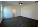 Comfortable bedroom with dark gray flooring, a ceiling fan, a window for natural light, and an ensuite bathroom at 951 Redwood St, Daytona Beach, FL 32117