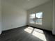 Bright bedroom with modern gray flooring and large window letting in natural light at 951 Redwood St, Daytona Beach, FL 32117
