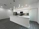 Modern kitchen featuring sleek white cabinetry, stainless steel appliances, an island with a sink, and pendant lighting at 951 Redwood St, Daytona Beach, FL 32117