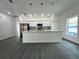 Open-concept kitchen boasting a large island, stainless steel appliances, and modern pendant lighting at 951 Redwood St, Daytona Beach, FL 32117