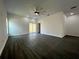 Expansive living room with a ceiling fan, dark wood-look floors, and sliding glass doors at 951 Redwood St, Daytona Beach, FL 32117