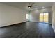 Spacious living room featuring modern ceiling fan, gray flooring, with sliding glass door that provides ample natural light at 951 Redwood St, Daytona Beach, FL 32117