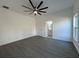 Spacious primary bedroom with large window, ceiling fan, and en-suite bathroom access at 955 Redwood St, Daytona Beach, FL 32117
