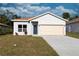 Charming single-story home featuring a neutral color scheme, attached garage, and well-maintained front lawn at 955 Redwood St, Daytona Beach, FL 32117