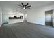 Spacious living room with modern lighting, ceiling fan, and gray wood-look flooring at 955 Redwood St, Daytona Beach, FL 32117