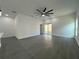 Open living area with sliding glass doors leading to backyard and gray wood-look flooring at 955 Redwood St, Daytona Beach, FL 32117