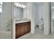 Bright bathroom with granite countertop, dark wood cabinets, and open doorway to the toilet at 1079 Lincolnshire Dr, Deland, FL 32724