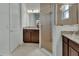 Bright bathroom featuring granite countertop, dark wood cabinets, and glass-enclosed shower at 1079 Lincolnshire Dr, Deland, FL 32724