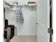 Bright closet featuring clothes rod and shelf, neatly arranged on carpeted floor at 1079 Lincolnshire Dr, Deland, FL 32724