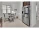 Cozy dining area with stainless steel refrigerator at 1079 Lincolnshire Dr, Deland, FL 32724