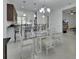 Bright dining area features a glass table and contemporary chandelier at 1079 Lincolnshire Dr, Deland, FL 32724