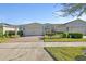Charming single-story home featuring a brick driveway and well-manicured landscaping at 1079 Lincolnshire Dr, Deland, FL 32724