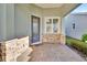 Inviting front porch with stone accents, tiled floor, and a stylish entryway at 1079 Lincolnshire Dr, Deland, FL 32724