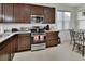 Close-up of kitchen with stainless steel appliances and granite counters at 1079 Lincolnshire Dr, Deland, FL 32724