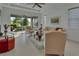 Well-lit living room with neutral decor, tile floors, and serene views at 1079 Lincolnshire Dr, Deland, FL 32724