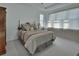 Calming main bedroom with tray ceiling and soft window lighting at 1079 Lincolnshire Dr, Deland, FL 32724