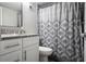 Bathroom features a white vanity with granite countertop and a decorative shower curtain at 100 Sweetgum Woods Ct # 10C, Deltona, FL 32725