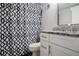 Bathroom features a white vanity with granite countertop and a black and white patterned shower curtain at 100 Sweetgum Woods Ct # 10C, Deltona, FL 32725