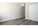 Bright bedroom featuring modern gray floors, a closet, and ample space at 100 Sweetgum Woods Ct # 10C, Deltona, FL 32725