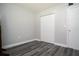 Bedroom with grey wood flooring and neutral paint, features a double door closet at 100 Sweetgum Woods Ct # 10C, Deltona, FL 32725
