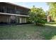 Back patio view of condo showing exterior and landscaping at 100 Sweetgum Woods Ct # 10C, Deltona, FL 32725