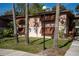 Condo exterior featuring unique shutters, mature trees, and well-manicured landscaping at 100 Sweetgum Woods Ct # 10C, Deltona, FL 32725