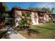 A charming condo exterior with unique shutters and well-maintained landscaping provides curb appeal at 100 Sweetgum Woods Ct # 10C, Deltona, FL 32725