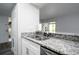 Granite countertop and stainless sink compliment this efficient kitchen design at 100 Sweetgum Woods Ct # 10C, Deltona, FL 32725