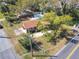 Aerial view of a brick home featuring a fenced backyard pool and mature trees in a suburban neighborhood at 1002 Charles St, Port Orange, FL 32129