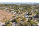Aerial view of a neighborhood with many single-Gathering homes, mature trees, and city views at 1002 Charles St, Port Orange, FL 32129