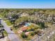 Aerial view of a cozy home with a fenced backyard pool surrounded by lush trees and a quiet neighborhood at 1002 Charles St, Port Orange, FL 32129