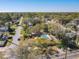 Aerial view of a home featuring a fenced backyard pool, surrounded by mature trees in a quiet neighborhood at 1002 Charles St, Port Orange, FL 32129