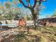 This property boasts a spacious backyard featuring a pool, mature trees, and a brick barbecue at 1002 Charles St, Port Orange, FL 32129