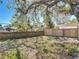 Newly fenced backyard with a large shade tree at 1002 Charles St, Port Orange, FL 32129