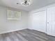 Bright bedroom with sleek flooring, window, and double door closet at 1002 Charles St, Port Orange, FL 32129