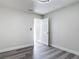 This bedroom showcases neutral walls, laminate flooring, and a doorway with natural light at 1002 Charles St, Port Orange, FL 32129