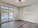 Bright bedroom featuring sleek flooring and sliding glass doors to a pool at 1002 Charles St, Port Orange, FL 32129