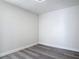 A view of a bedroom with neutral walls, sleek flooring, and minimalist design at 1002 Charles St, Port Orange, FL 32129